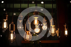 closeup on group of different Vintage Edison Light Bulb types illuminated