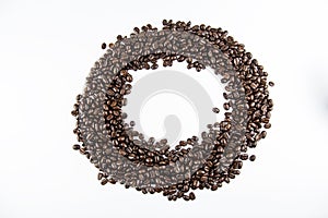 Closeup group of roasted coffee beans on white background.circle pattern photo