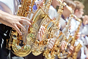Closeup of a group of saxophonists.