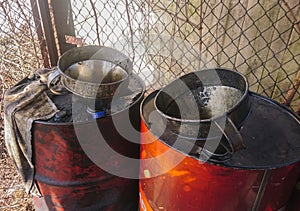 Closeup grungy, dirty old oil drum with metallic funnel