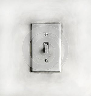 Closeup of a grungy dirty old white light switch on a wall
