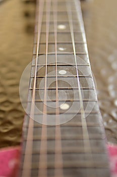 Closeup of Guitar Strings and Frets photo