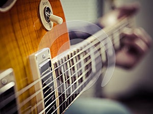 Closeup of guitarist playing electric guitar