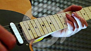 Closeup Guy Plays Guitar Touches Neck in Studio