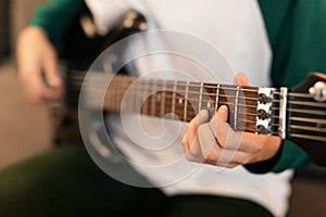 Closeup Of Guy& x27;s Hands Playing Chords On Electric Guitar Indoor