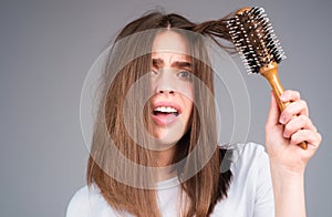 Closeup hair loss, hair fall in hairbrush, stress problem of woman with a comb.