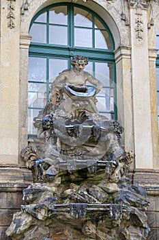 Closeup half naked faunus statues fountain at Zwinger palace in