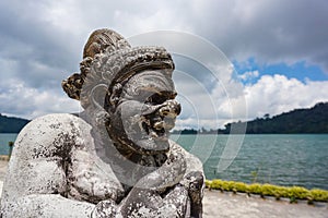 Closeup of a half size stone carved statue depicting a warrior god in Balinese Hindu temple, Bali, Indonesia