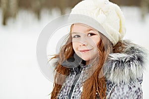 Closeup half-turned portrait of little girl in grey jacket