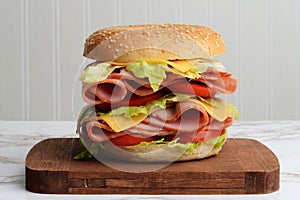 Closeup ham cheese tomato lettuce bagel sandwich