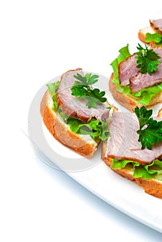 Closeup ham, salad and parsley canapes