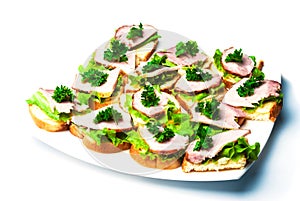 Closeup ham, salad and parsley canapes