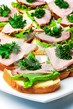 Closeup ham, salad and parsley canapes