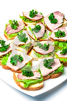 Closeup ham, salad and parsley canapes