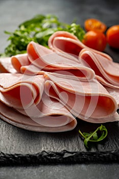 Closeup ham slices, over dark background