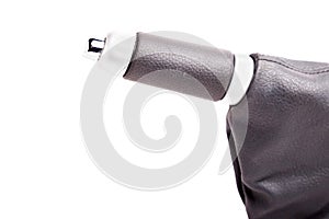 Closeup of a hand brake lever with a white handle with chrome elements of an expensive German auto on an isolated background in a