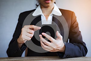Closeup hand of business woman using smart mobile phone at office