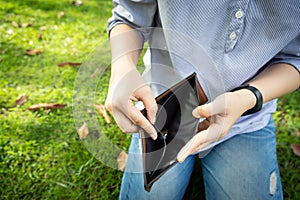 Closeup hand of businesswoman holding a wallet,hand open an empty wallet,asian woman shows her empty money in wallet,bad economics