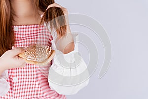 Closeup hand holding comb and hair fall problem isolated grey background