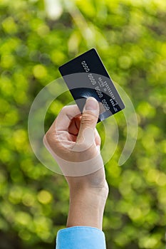 Closeup of hand holding credit card, ready for payment