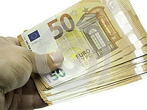 Closeup hand holding pack of 50 euro banknotes or bills isolated on white