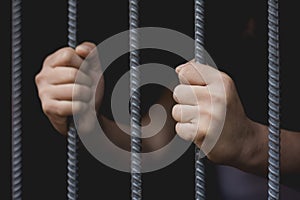 Closeup of a hand holding a steel cage in prison, prisoner concept, Hope to be free.