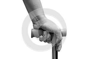 Closeup of hand holding a walking stick or a cane,  on white background. Medical and healthcare concept. Black & White ton