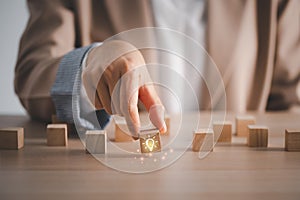 Closeup hand holding wood cube with light bulb icon