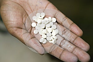 A closeup of a hand holds AIDS pills at the Pepo La Tumaini Jangwani, HIV/AIDS Community Rehabilitation Program, Orphanage &