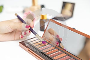 Closeup of hand makeup artist testing different eyeshadows