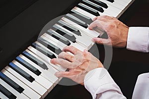 Closeup hand man playing piano. Classical music instrument