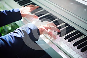 Closeup hand man playing piano. Classical music instrument. Fade color tone.