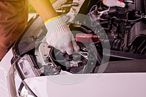 Closeup of hand mechanic engineer fixing car battery at garage