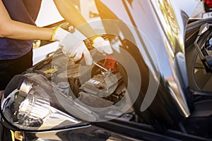 Closeup of hand mechanic engineer fixing car battery at garage