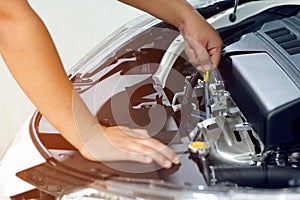 Closeup hand mechanic service car check engine oil