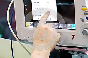 Closeup hand of nurse setting of function at BP, Vital sign and Heart rate monitor in hospital