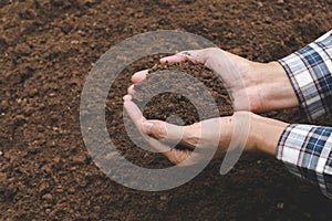 Closeup hand of person holding abundance soil for agriculture or