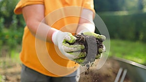 closeup hand of person holding abundance soil with young plant. Concept green world earth day. Hand of farmer inspecting