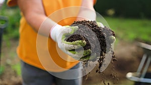 closeup hand of person holding abundance soil with young plant. Concept green world earth day. Hand of farmer inspecting