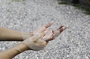 Closeup hand of person massage her hand from pain in healthy concept on nature background