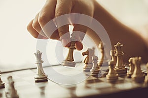 Closeup hand playing chess moving chesspiece step forward