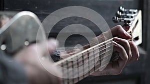 Closeup of hand playing guitar
