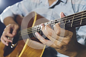 Closeup of hand playing guitar