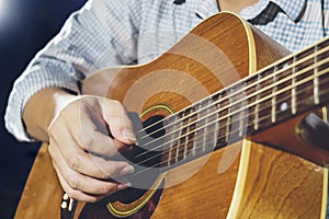 Closeup of hand playing guitar