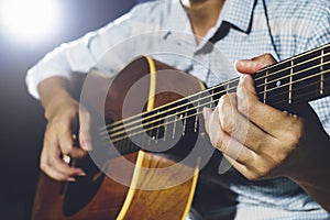 Closeup of hand playing guitar