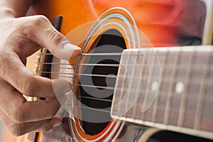 Closeup hand playing guitar