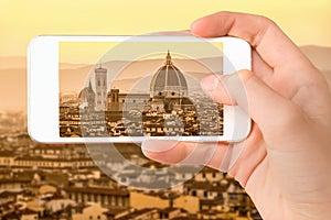 Closeup of a hand with smartphone taking a picture of Florence with the Basilica Santa Maria del Fiore Duomo, Tuscany Italy