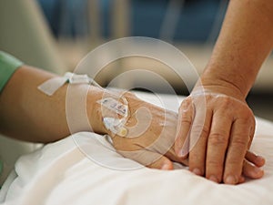 Closeup Hand to encourage Patients sleep to saline at the hospital ward get well soon