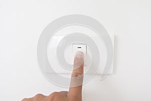 Closeup hand turn off a power button,Finger press light button,Hand with Power plug,interior electric power button in home,Concept