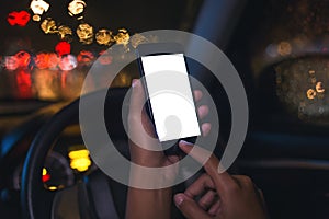 Closeup hand using phone inside car on night in city